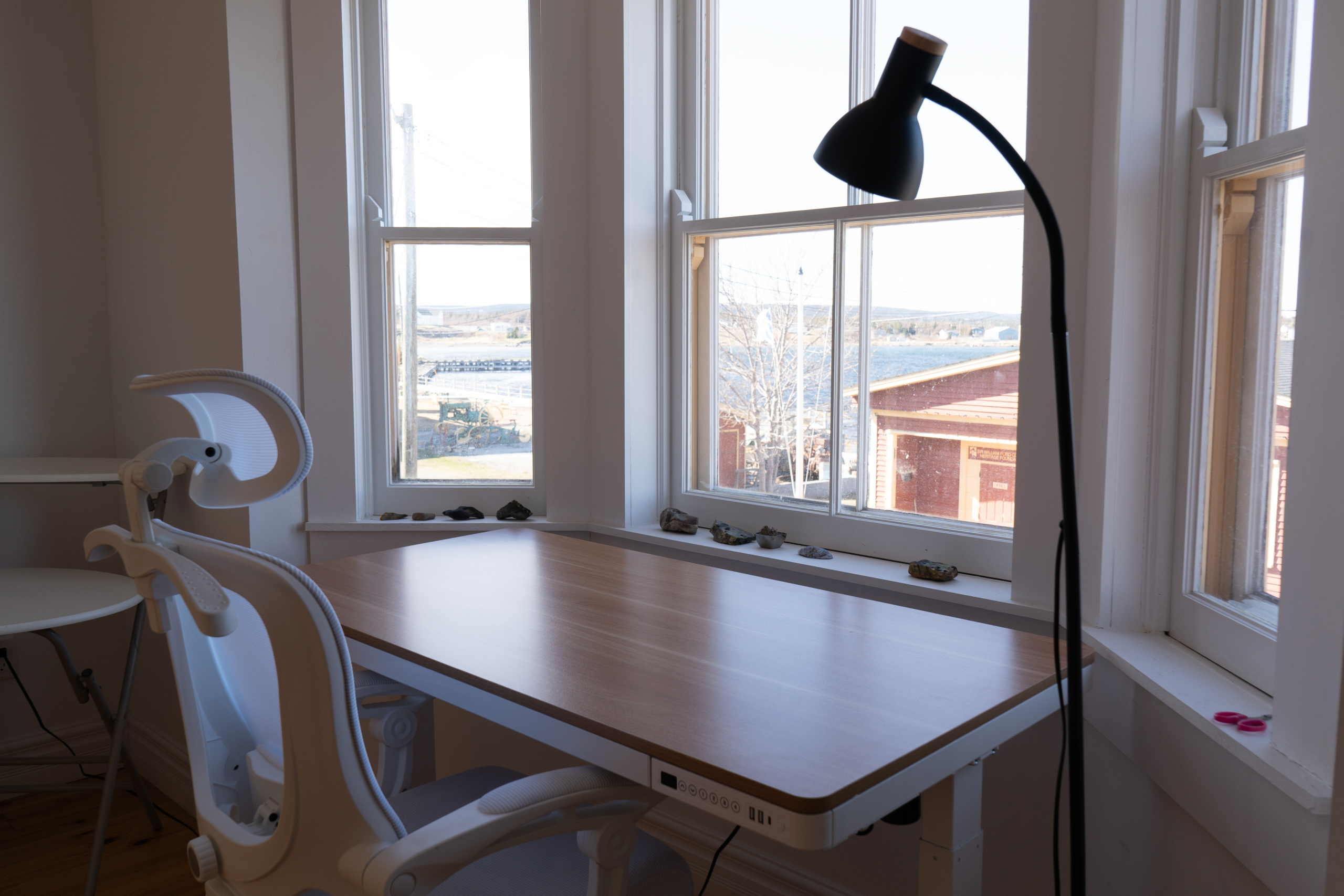 Close-up of the standing desk, placed in front of a bay window overlooking Port Union.