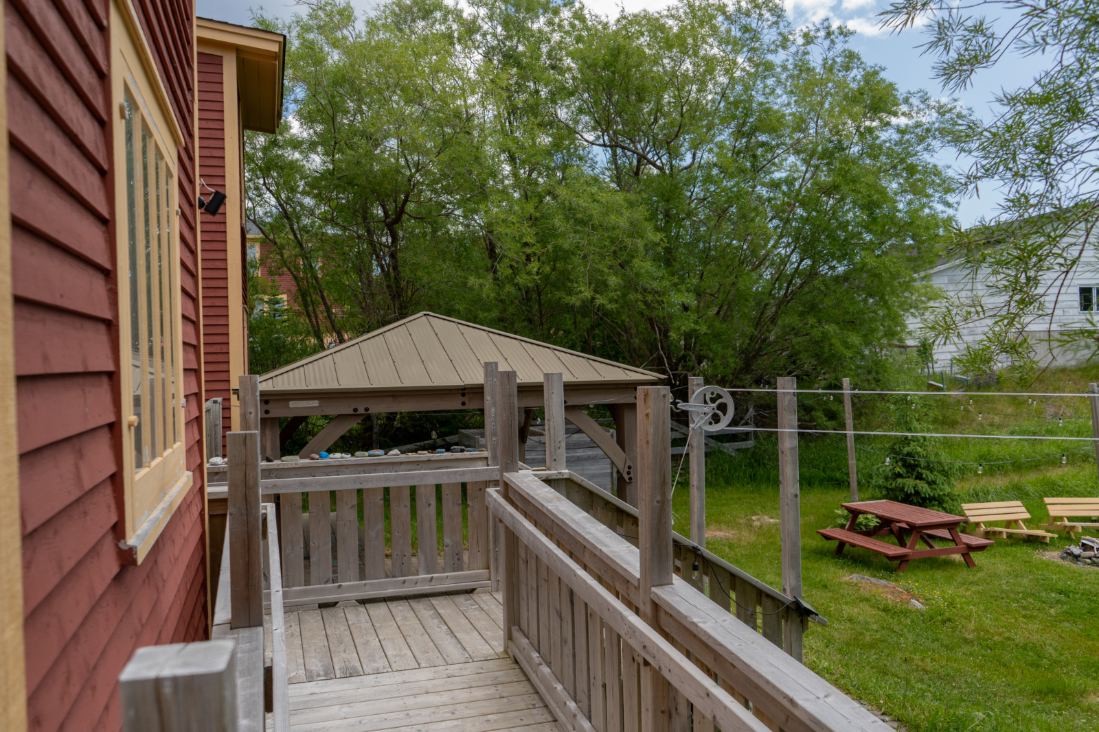 Looking out towards the garden and patio; the awning of the maker space and the side of the building is visible.