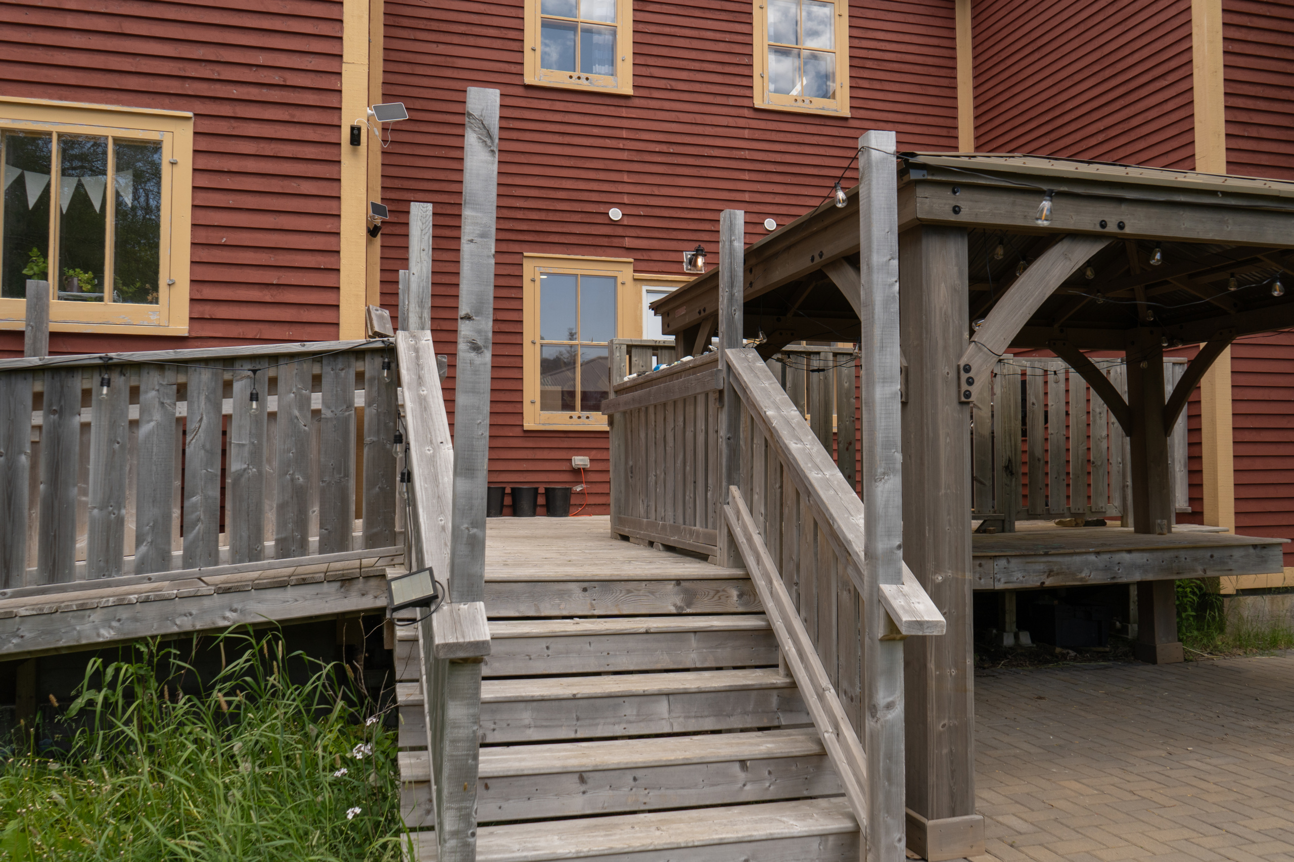 Looking at the patio and makers space from the bottom of the garden stairs.