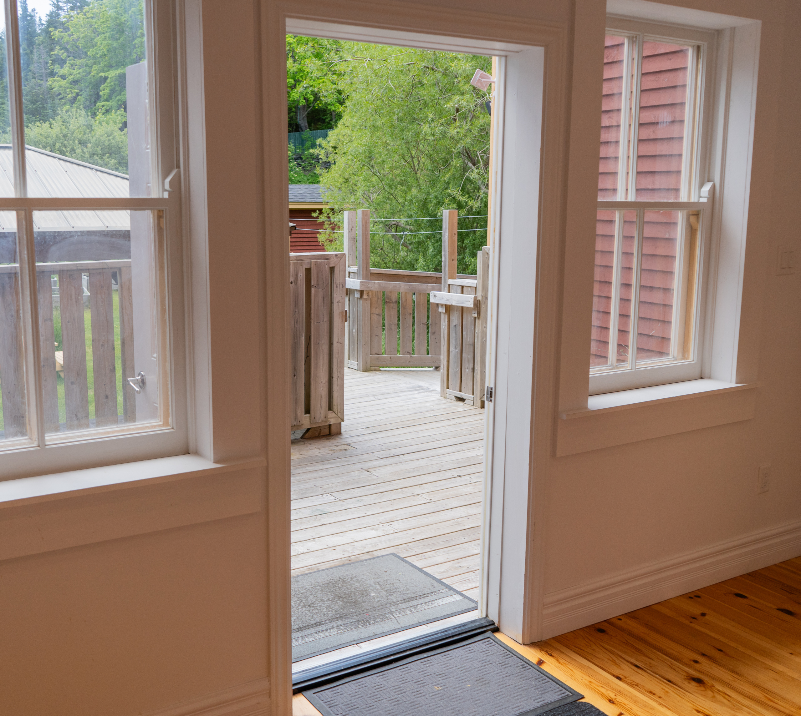 The patio and wheelchair ramp system, seen from inside the gallery space through an open door